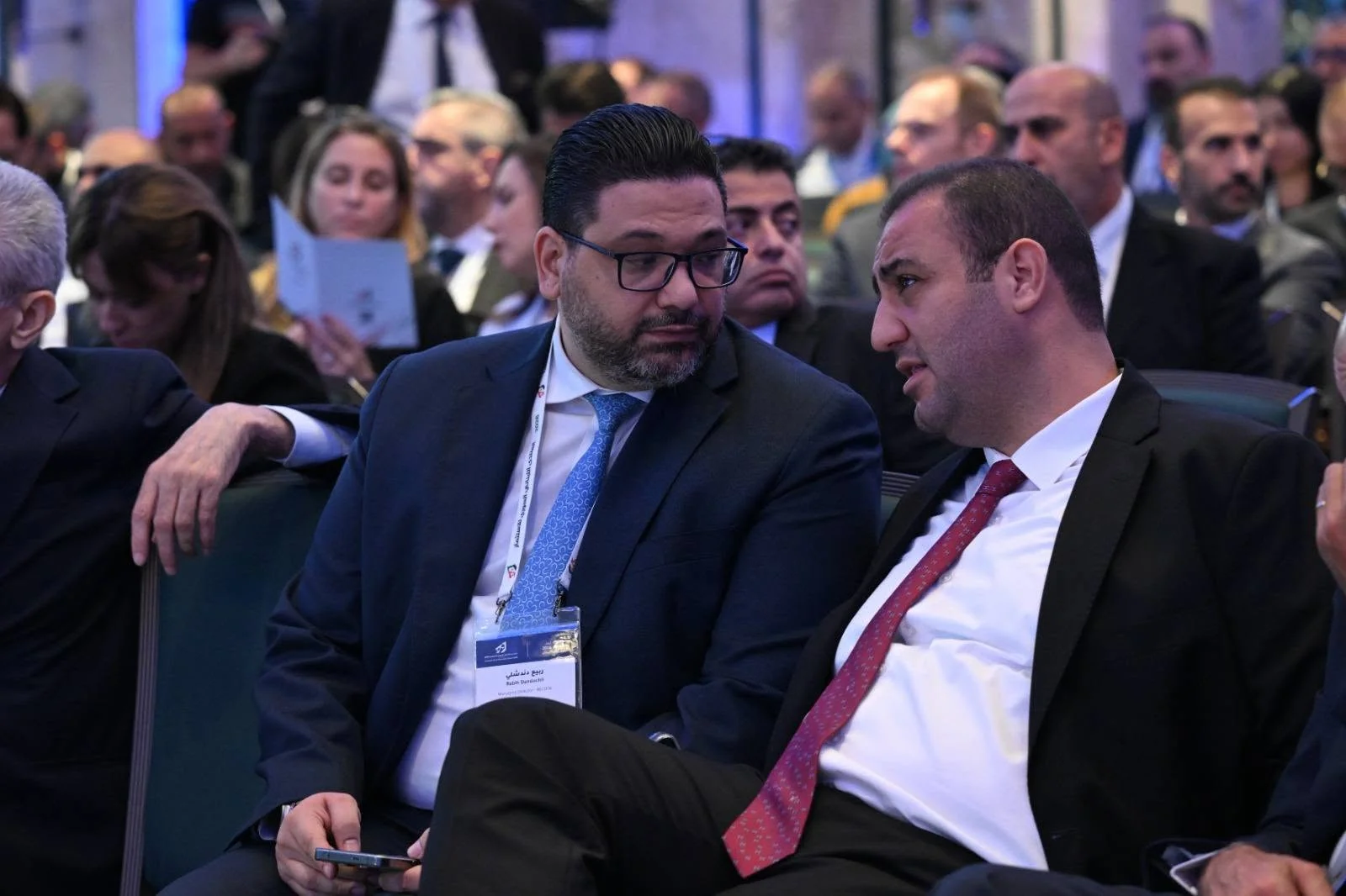 Speaking with a fellow participant during the forum